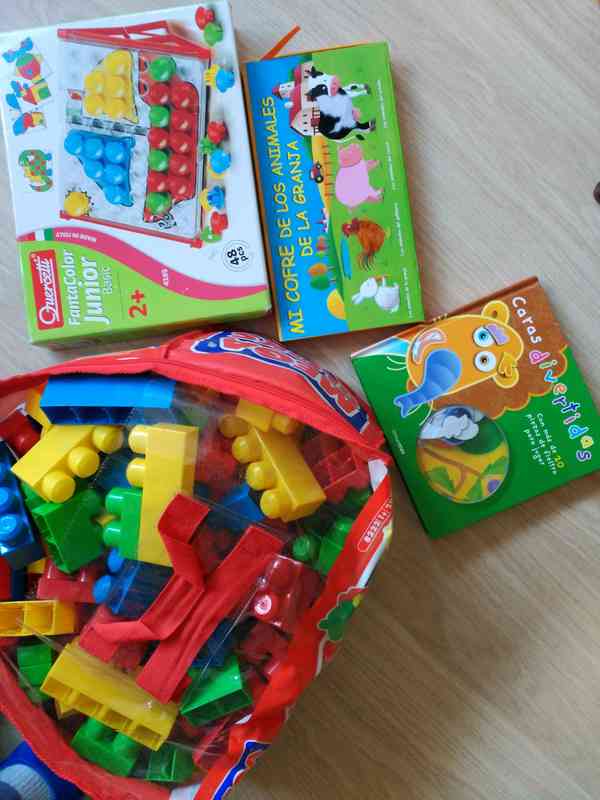 Juguetes y libro para niños de unos 3 años.